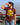 Beautiful scenary of mountains with a woman wearing a brown printed tshirt with the text Twenty Four Karats