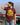 Beautiful scenary of mountains with a woman wearing a brown printed tshirt with the text Twenty Four Karats